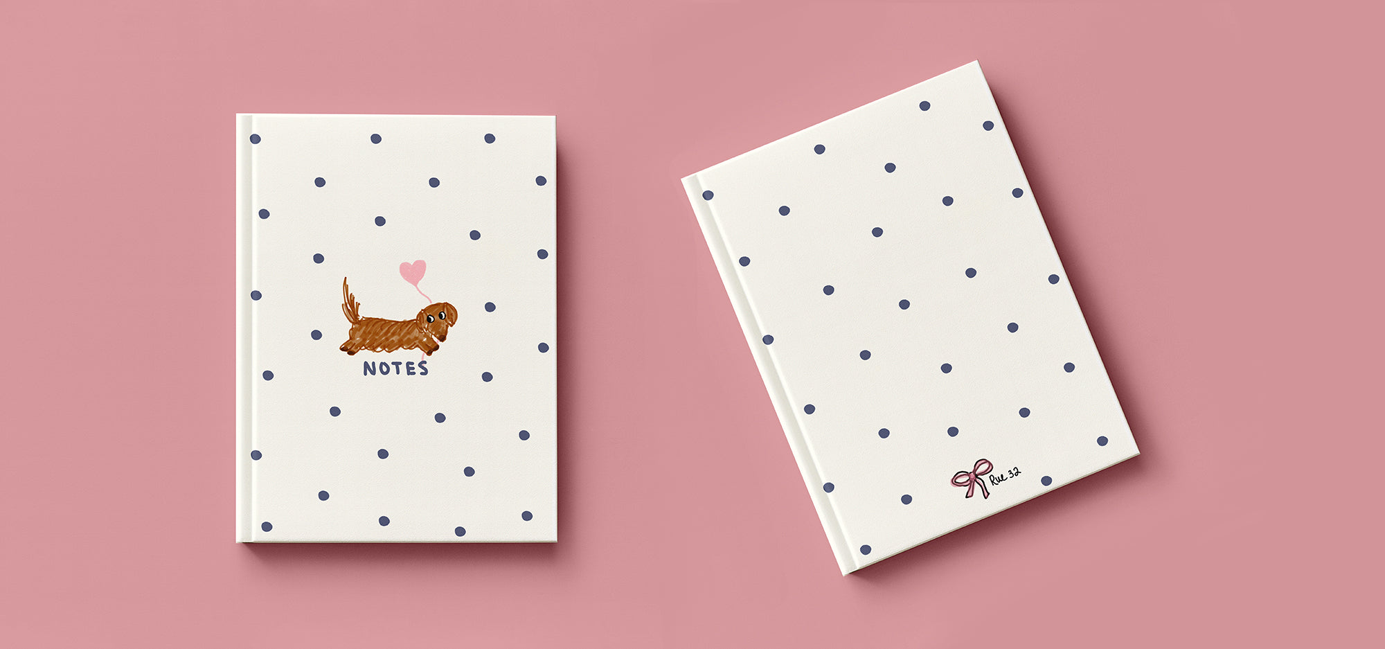 Two notebooks with polka dot designs on a pink background